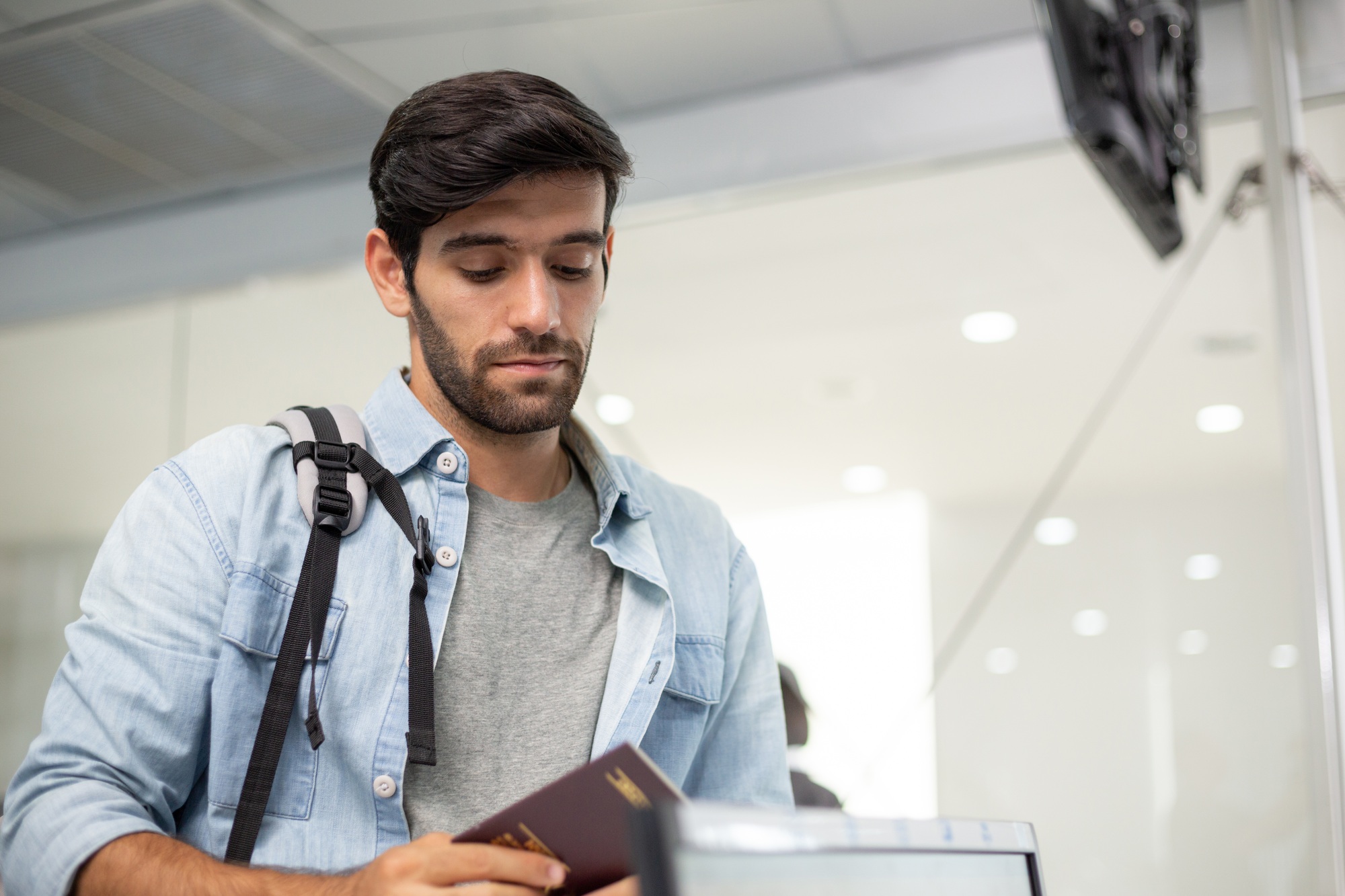 Caucasian tourist man check-in at airline counter service.